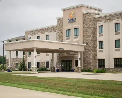 a large building with a sign on the front of it at Comfort Inn & Suites Caldwell in Caldwell
