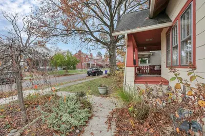 a house with a red porch on a street at The Orchard Oasis in Columbus