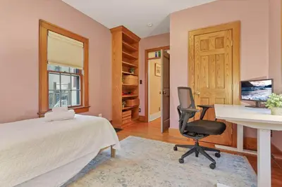 a bedroom with a bed and a desk and a chair at The Orchard Oasis in Columbus