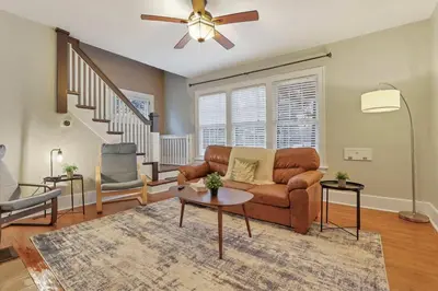 a living room with a couch and a ceiling fan at The Orchard Oasis in Columbus