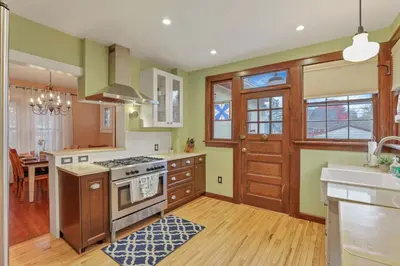a kitchen with wooden cabinets and a stove top oven at The Orchard Oasis in Columbus