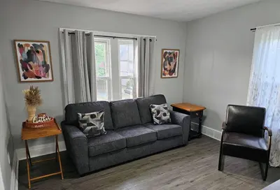 a living room with a couch and a window at Spacious in the heart of it all in Cleveland