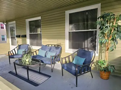 three blue chairs and a table on a porch at Spacious in the heart of it all in Cleveland