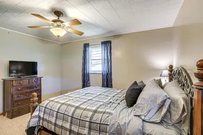 a bedroom with a bed and a ceiling fan at Stay and Play West Virginia Country Home! in Davisville