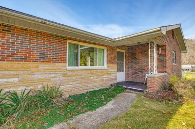 a brick house with a porch and a window at Stay and Play West Virginia Country Home! in Davisville