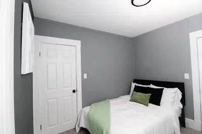 a bedroom with a bed with green and white at Modern Luxury in Tremont - 6Bed 3bath Fee parking in Cleveland