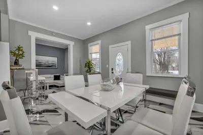 a dining room with a white table and white chairs at Modern Luxury in Tremont - 6Bed 3bath Fee parking in Cleveland