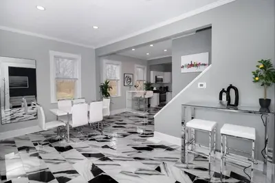 a living room with a black and white floor and white chairs at Modern Luxury in Tremont - 6Bed 3bath Fee parking in Cleveland