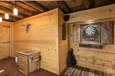 a log cabin with a dart board on the wall at Coschocton Hills - 2 Luxury Log Cabins - Lake in Coshocton