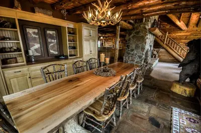 a dining room with a long wooden table and chairs at Coschocton Hills - 2 Luxury Log Cabins - Lake in Coshocton