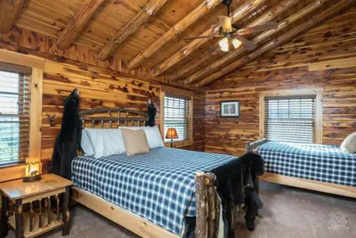 a bedroom with two beds in a log cabin at Coschocton Hills - 2 Luxury Log Cabins - Lake in Coshocton