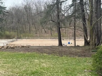 a volleyball court in a park with trees and grass at The House Hotels - Acadia Farms in Northfield