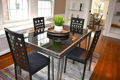 a dining room table with chairs and a plant on it at The House Hotels - Acadia Farms in Northfield