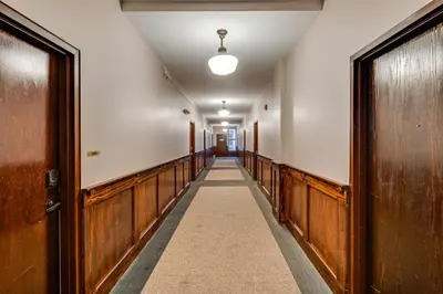 an empty corridor with wooden doors and a hallway with a hallway at Walk to Convention Center, Secured Apt in Columbus in Columbus
