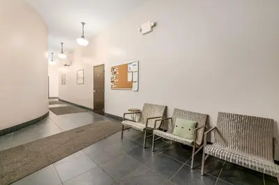 a hallway with two chairs and a table at Walk to Convention Center, Secured Apt in Columbus in Columbus