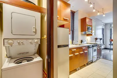 a kitchen with a washer and dryer in it at Walk to Convention Center, Secured Apt in Columbus in Columbus