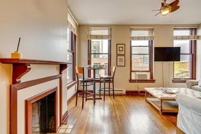 a living room with a fireplace and a table at Walk to Convention Center, Secured Apt in Columbus in Columbus