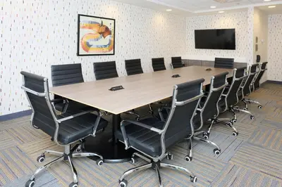 a conference room with a large table and chairs at Home2 Suites By Hilton Lima in Lima