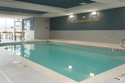 a swimming pool with blue water in a building at Home2 Suites By Hilton Lima in Lima