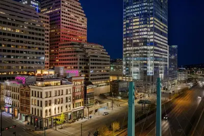 a city skyline with tall buildings at night at Moxy Cincinnati Downtown in Cincinnati