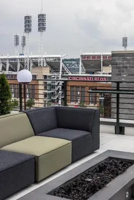 a couch sitting on top of a building with a stadium at Moxy Cincinnati Downtown in Cincinnati