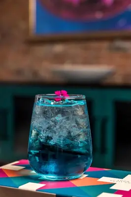 a glass vase with a flower in it on a table at Moxy Cincinnati Downtown in Cincinnati