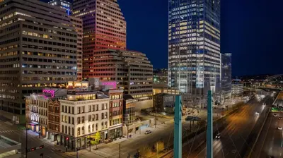 a city skyline with tall buildings at night at Moxy Cincinnati Downtown in Cincinnati
