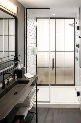 a bathroom with a shower and a sink at Moxy Cincinnati Downtown in Cincinnati