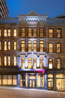 a large brick building with a sign on it at Moxy Cincinnati Downtown in Cincinnati