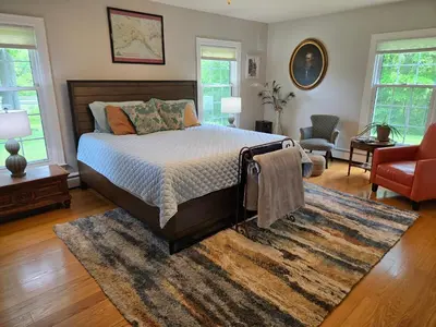a bedroom with a bed and a rug at Large private retreat near Summit Lake in New Castle