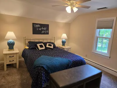 a bedroom with a bed and a ceiling fan at Large private retreat near Summit Lake in New Castle