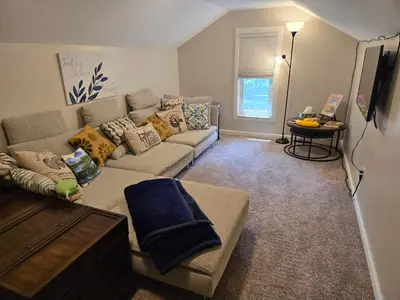 a living room with a couch and a table at Large private retreat near Summit Lake in New Castle