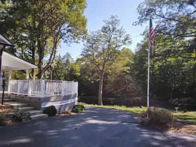 a house with a flag on the side of a driveway at Large private retreat near Summit Lake in New Castle