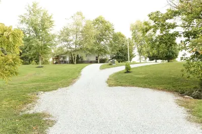 a gravel road in front of a house at Maple Lawn in Moores Hill