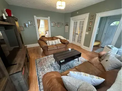 a living room with a couch and a table at Charming 2BR Home with Office in Cleveland