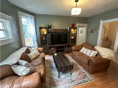 a living room with two couches and a television at Charming 2BR Home with Office in Cleveland