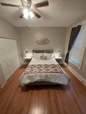 a bedroom with a bed and a ceiling fan at Charming 2BR Home with Office in Cleveland