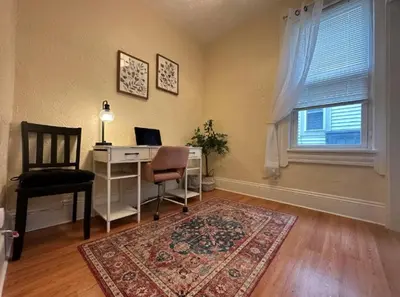 a home office with a desk and a chair and a window at Charming 2BR Home with Office in Cleveland