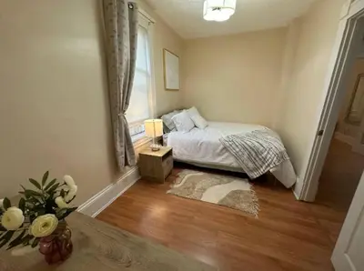 a bedroom with a bed and a window at Charming 2BR Home with Office in Cleveland