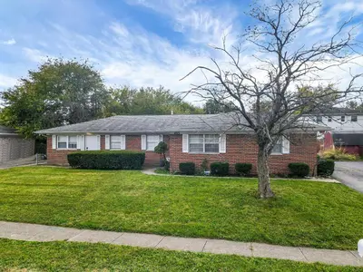 a brick house with a tree in the yard at The Gahanna Getaway in Gahanna