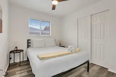 a white bedroom with a bed with two towels on it at The Gahanna Getaway in Gahanna