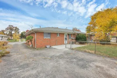 a brick house with a fence in front of it at The Gahanna Getaway in Gahanna