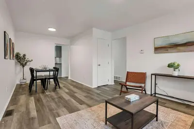 a living room with a table and a dining room at The Gahanna Getaway in Gahanna
