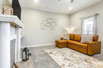 a living room with a couch and a fireplace at 3 Mi to Dtwn Covington Getaway with Backyard in Covington
