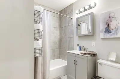 a bathroom with a shower and a toilet and a sink at 3 Mi to Dtwn Covington Getaway with Backyard in Covington