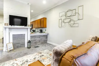 a living room with a couch and a fireplace at 3 Mi to Dtwn Covington Getaway with Backyard in Covington