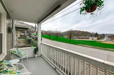 a balcony with chairs and a view of a street at 3 Mi to Dtwn Covington Getaway with Backyard in Covington