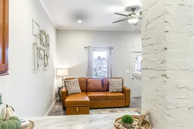 a living room with a couch and a ceiling fan at 3 Mi to Dtwn Covington Getaway with Backyard in Covington