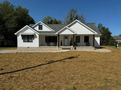 a white house with a large yard at Beck Lake House in Kelleys Island