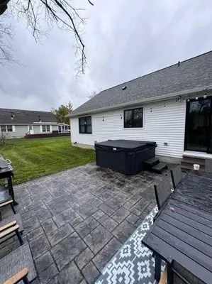 a patio with a table and a bench and a house at Beck Lake House in Kelleys Island